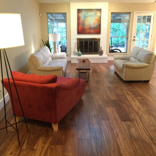 living room with hardwood floor Peoples Signature Flooring Austin Texas, 7.5 Inch Wide Hand Sculpted Acacia Natural 1x8 Baseboards